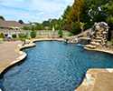 Freeform Custom Swimming Pool With Slide by Conway Pool Builders