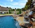 Freeform Custom Swimming Pool With Slide by Conway Pool Builders