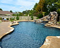 Freeform Custom Swimming Pool With Slide by Conway Pool Builders