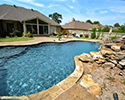Freeform Custom Swimming Pool With Slide by Conway Pool Builders