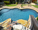 Freeform Custom Swimming Pool With Slide by Conway Pool Builders