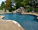 Freeform Custom Swimming Pool With Slide by Conway Pool Builders