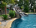 Freeform Custom Swimming Pool With Slide by Conway Pool Builders